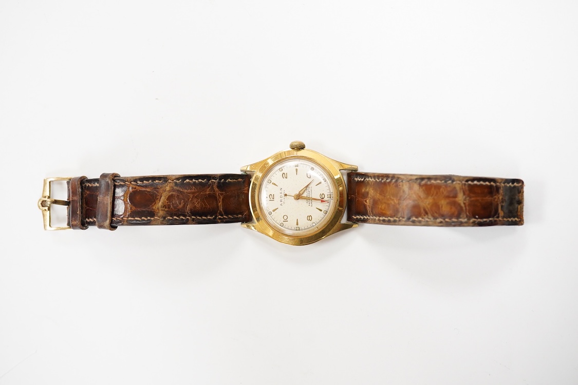 A gentleman's mid 20th century steel and gold plated Arden 'Super Automatic' wrist watch, with baton and Arabic numerals and seep seconds with red arrow pointer, case diameter 33mm, on an Omega brown leather strap.